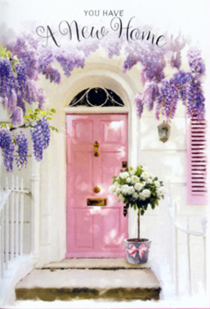 In this evocative Cranford doorway scene, a painted pink door becomes the soft-hearted centrepiece of a story about moving into a new home and starting afresh. The door's pastel blush stands out against the whitewashed walls, its colour carried subtly into the single shutter beside it, creating a harmonious, almost storybook façade reminiscent of the quiet residential streets off Cranford High Street. Overhead, wisteria falls in luxurious, lavender-hued clusters, each blossom hanging like a tiny bell, together forming a curtain of colour that frames the entrance with gentle drama. The light appears to be late morning or early afternoon, washing over the façade with a golden softness so familiar in this part of West London, casting faint shadows that add depth without disturbing the tranquillity. On the doorstep, a chic metal bucket has been placed with care, filled to overflowing with creamy white roses. Their petals are plush and velvety, cupped around one another to form full, generous blooms that speak of comfort and quiet joy. Sprigs of soft green foliage weave between the roses, adding movement and a hint of woodland freshness, as if they were gathered after a walk through nearby Cranford Park. A satin pink ribbon encircles the base of the bucket, its smooth sheen catching the light and mirroring the tones of the door above. The overall mood is one of calm anticipation and heartfelt welcome, an image that captures how flowers can transform a bare doorway into a home, perfect for a housewarming gesture or a congratulatory delivery to celebrate settling into a new address in Cranford.